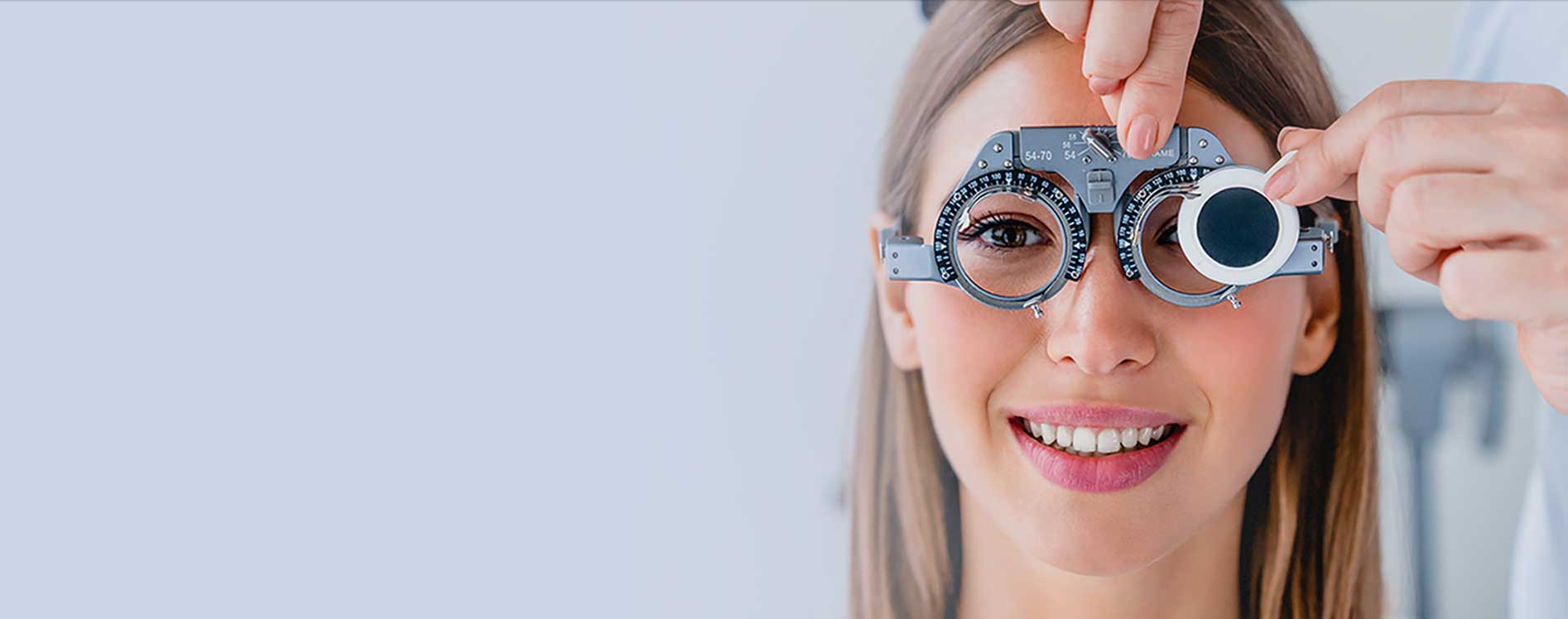 A women smiling while getting her eyes tested
