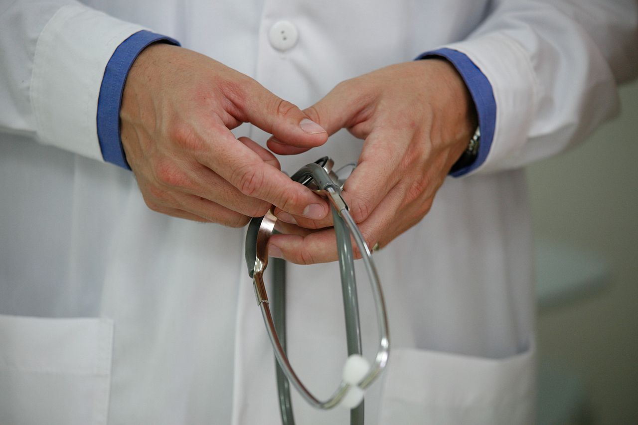 Close up of a doctor hands as they loosely hold a stethoscope