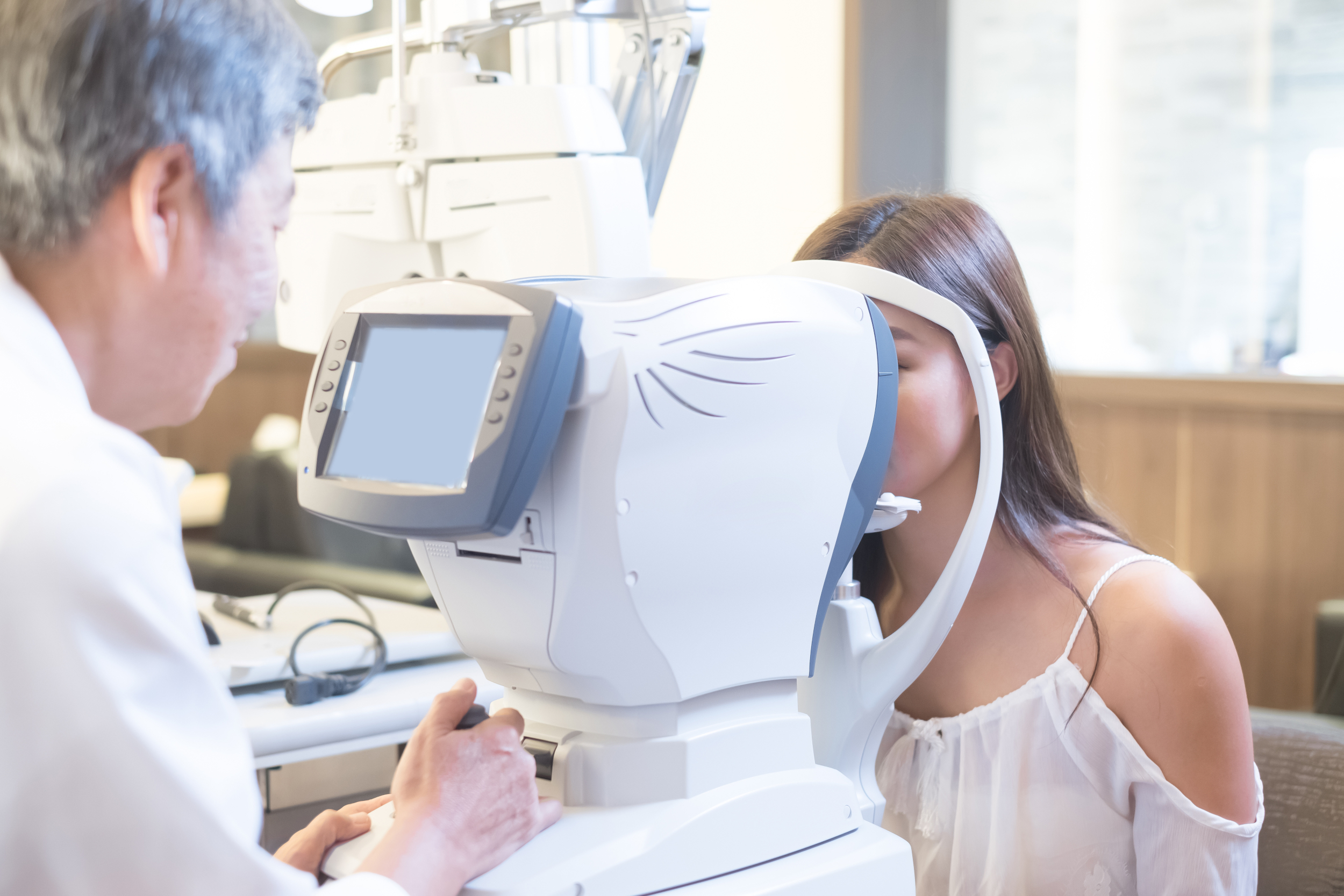 A doctor examining her patients eyes